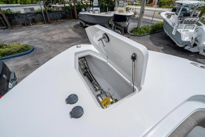 Slide: The Image of 2025 Sea Hunt Gamefish 28 CB boat with open storage compartment on deck. - 29