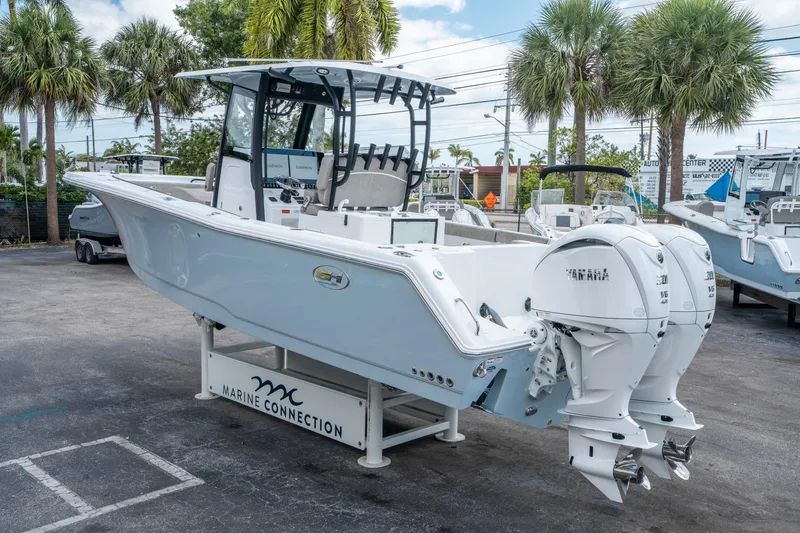 Slide: The Image of 2025 Sea Hunt Gamefish 28 CB boat with dual Yamaha engines, displayed outdoors. - 4