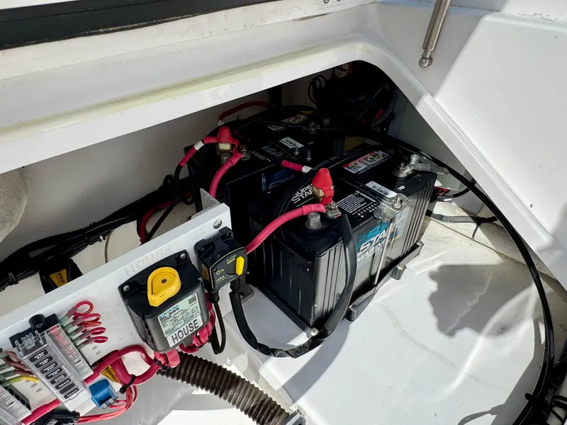 Slide: The Image of 2019 Everglades 253CC boat battery compartment with wiring and connections. - 10