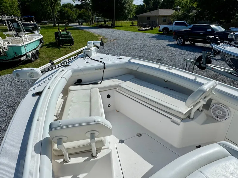 Slide: The Image of 2019 Everglades 253CC boat with spacious seating, parked outdoors on gravel. - 12