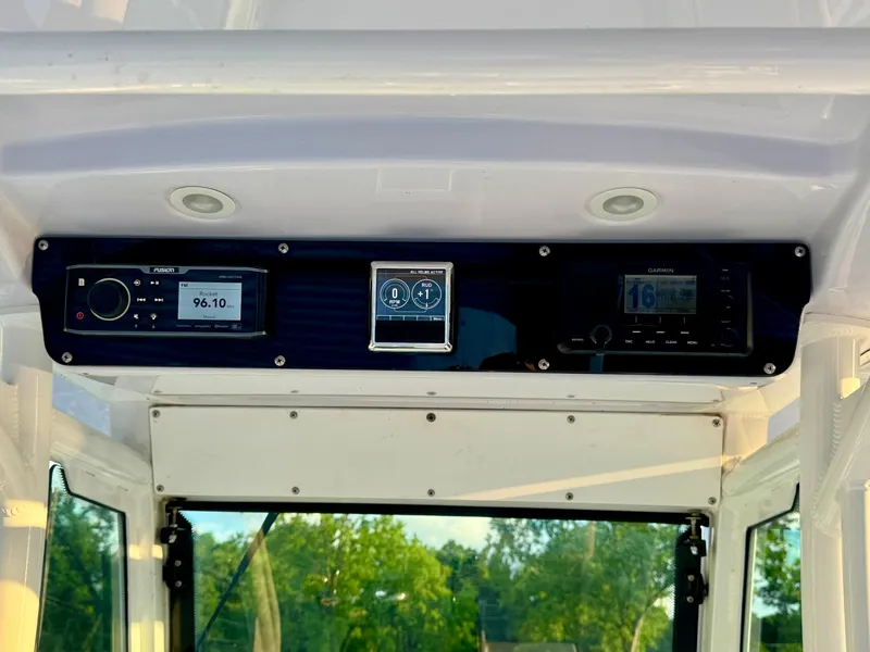 Slide: The Image of 2019 Everglades 253CC boat dashboard with radio and navigation displays. - 16