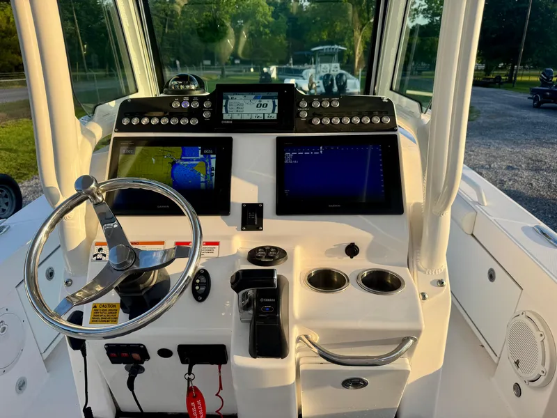 Slide: The Image of 2019 Everglades 253CC boat dashboard with steering wheel and navigation screens. - 17