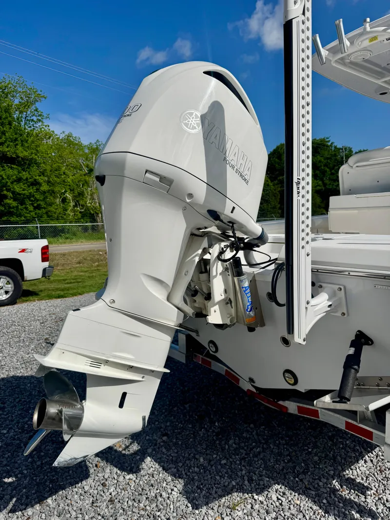 Slide: The Image of 2019 Everglades 253CC boat with powerful outboard motor, parked on gravel. - 3