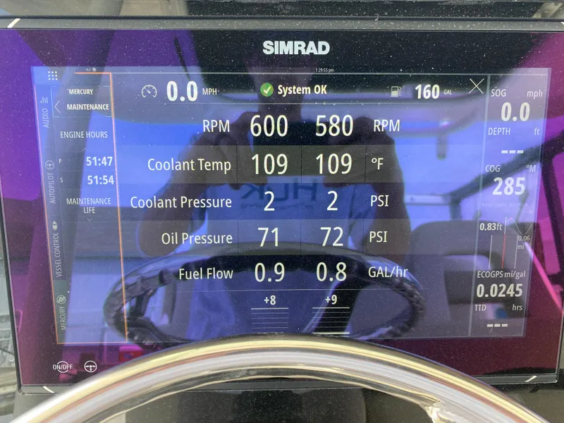 Slide: The Image of Simrad display on 2023 Boston Whaler 330 Outrage showing engine metrics and system status. - 25
