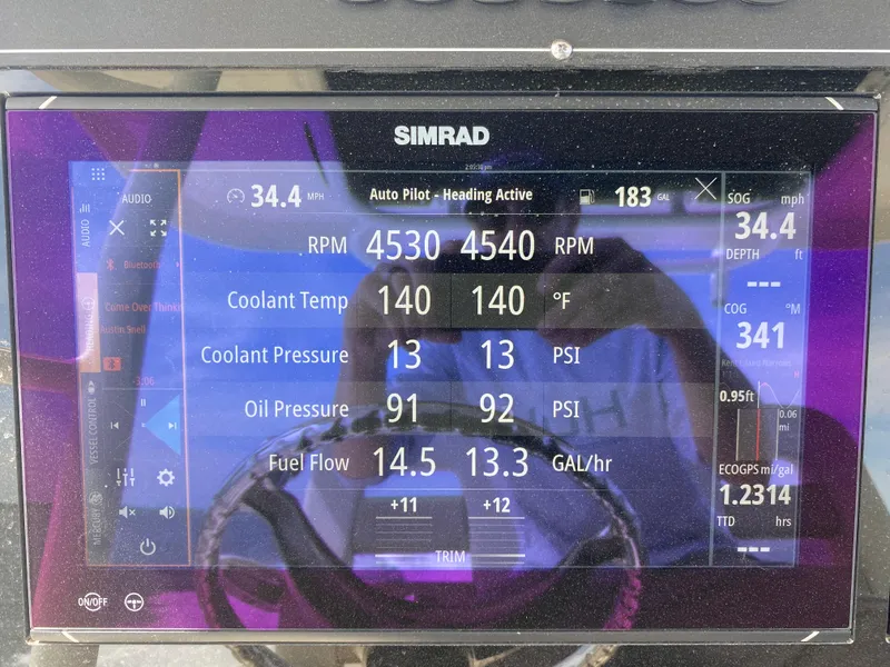 Slide: The Image of Simrad display on 2023 Boston Whaler 330 Outrage showing engine and navigation data. - 26