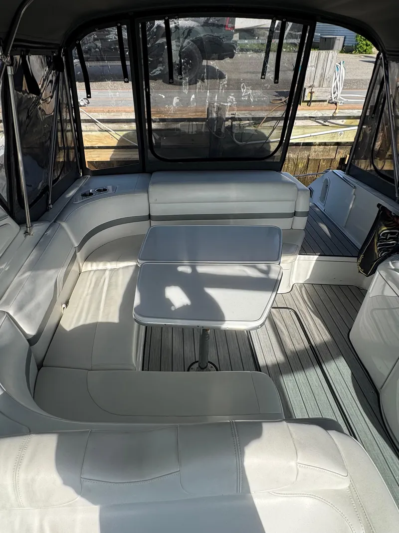 Slide: The Image of 2007 Formula 330 SS boat interior with white seating and table. - 11