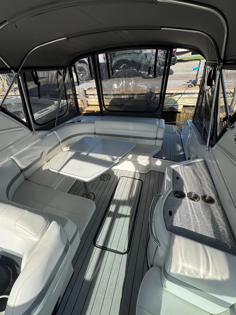 Slide: The Image of 2007 Formula 330 SS boat interior with seating and table, featuring a sleek design and canopy. - 15