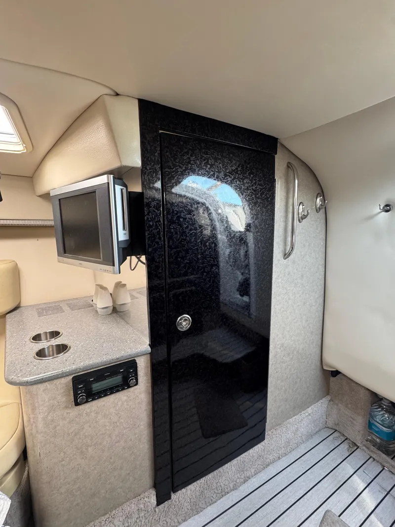 Slide: The Image of Interior of 2007 Formula 330 SS boat with kitchenette and black cabinet. - 24