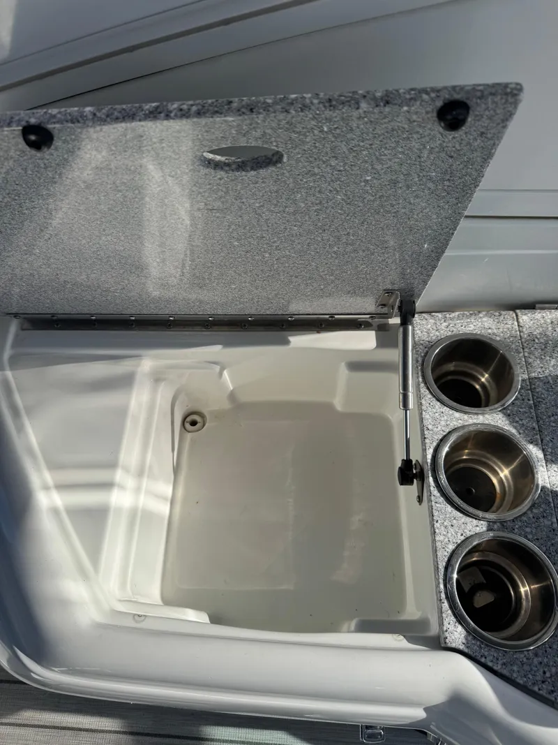 Slide: The Image of Open storage compartment and cup holders on 2007 Formula 330 SS boat. - 9
