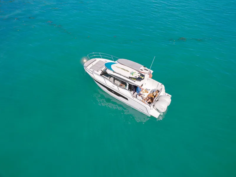 Slide: The Image of 2025 Jeanneau NC895 S2 boat on clear turquoise water, aerial view. - 4