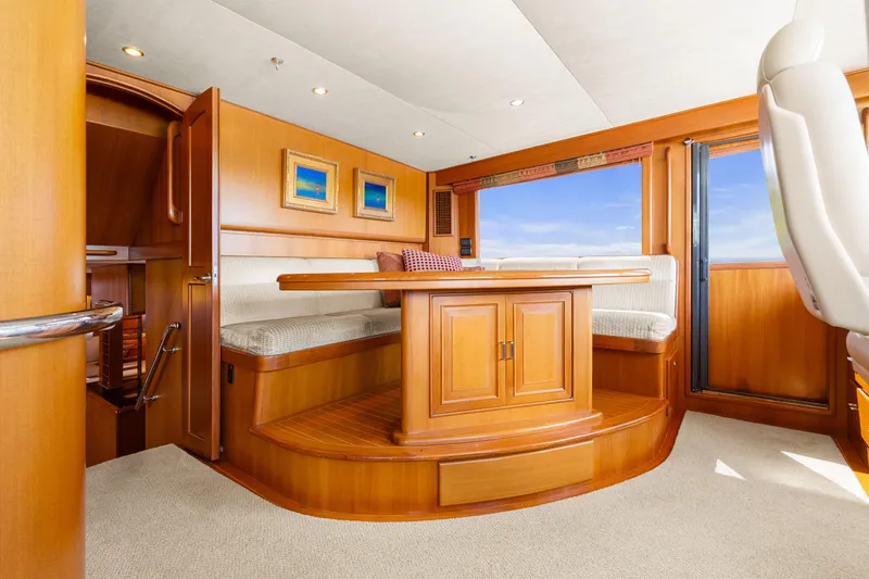 Slide: The Image of Luxurious interior of a 2006 Fleming 75 yacht with elegant wood finishes and seating area. - 14
