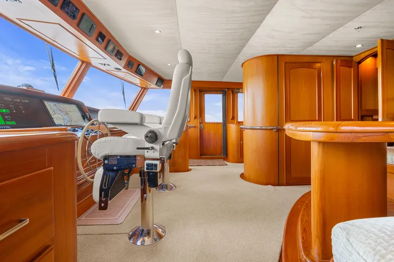 Slide: The Image of Luxurious interior of a 2006 Fleming 75 yacht with elegant wood finishes and modern navigation equipment. - 20