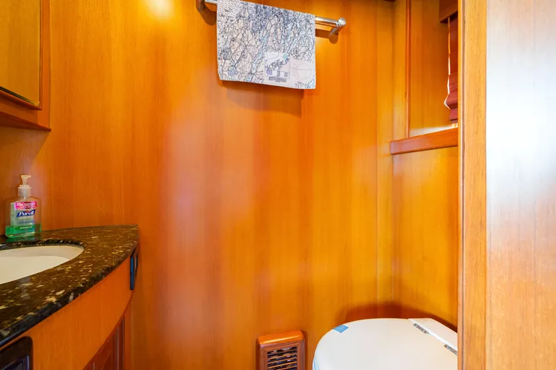 Slide: The Image of Luxurious wooden bathroom interior on a 2006 Fleming 75 yacht, featuring a granite countertop. - 21