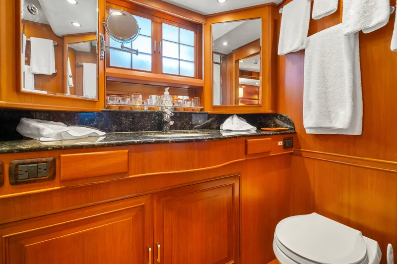 Slide: The Image of Luxurious bathroom in 2006 Fleming 75 yacht with wood cabinetry and granite countertop. - 28