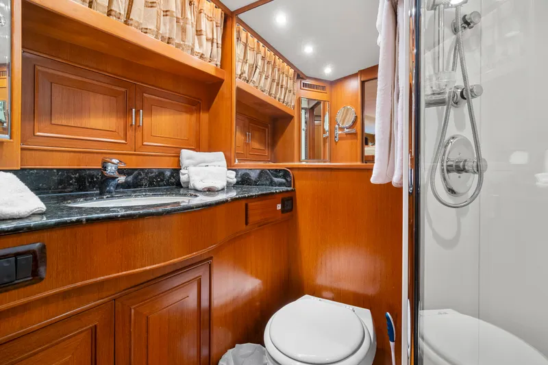 Slide: The Image of Luxurious bathroom in 2006 Fleming 75 yacht with wood cabinetry and modern fixtures. - 32