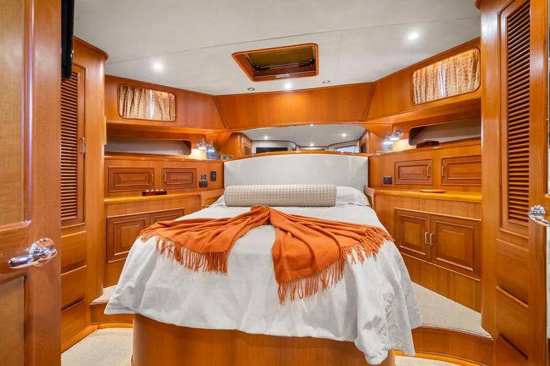 Slide: The Image of Luxurious cabin interior of a 2006 Fleming 75 yacht with elegant wood finish and cozy bedding. - 33