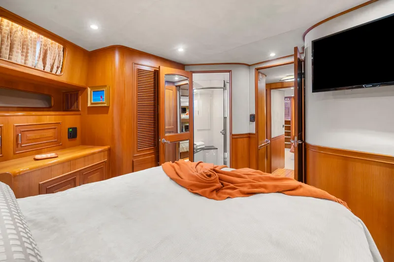 Slide: The Image of Luxurious cabin interior of a 2006 Fleming 75 yacht with wood paneling and modern amenities. - 34