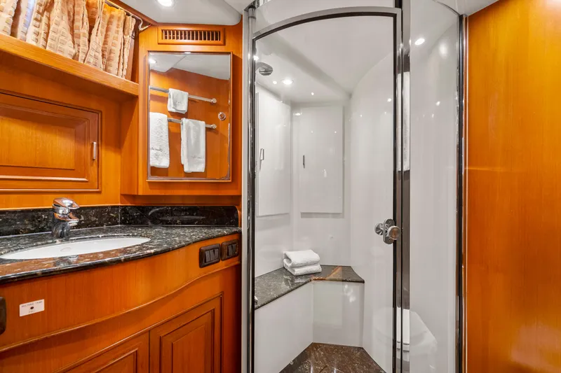Slide: The Image of Luxurious bathroom in 2006 Fleming 75 yacht with wood cabinetry and glass shower. - 35