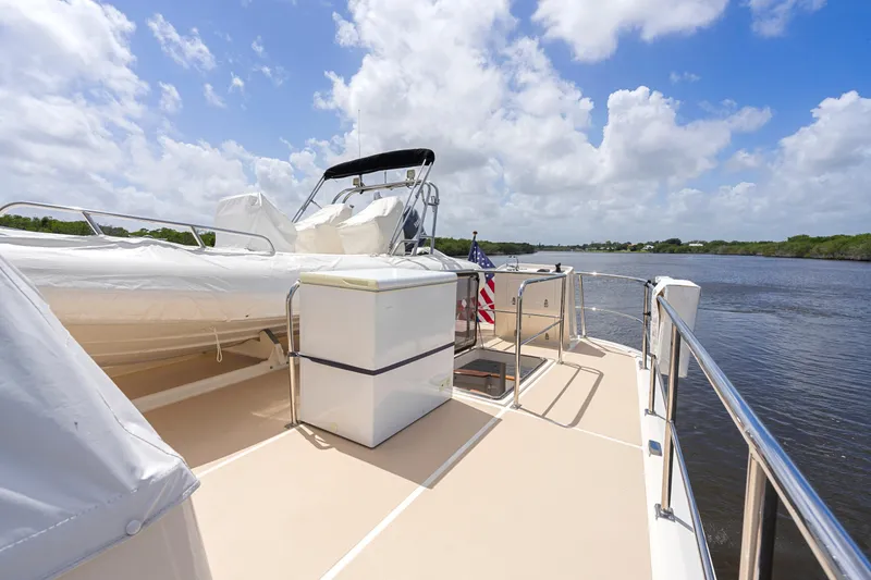 Slide: The Image of Luxurious 2006 Fleming 75 yacht deck with scenic river view and clear skies. - 46