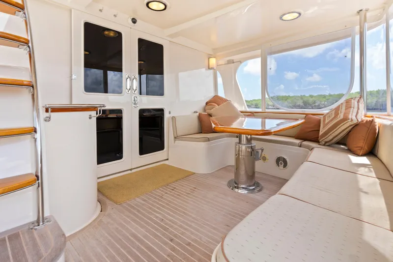 Slide: The Image of Luxurious interior of a 2006 Fleming 75 yacht with elegant seating and scenic windows. - 49