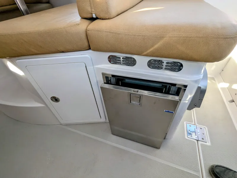 Slide: The Image of 2014 Back Cove 34 interior with seating and built-in stainless steel refrigerator. - 12