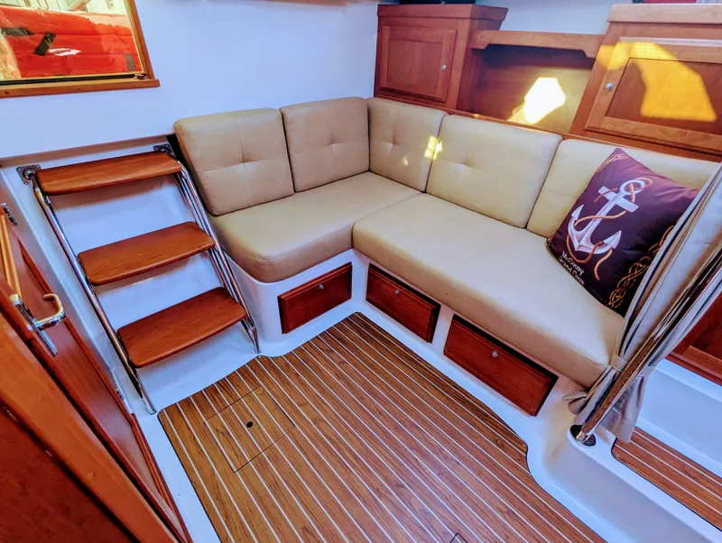 Slide: The Image of Interior of 2014 Back Cove 34 boat with cushioned seating and wooden flooring. - 16
