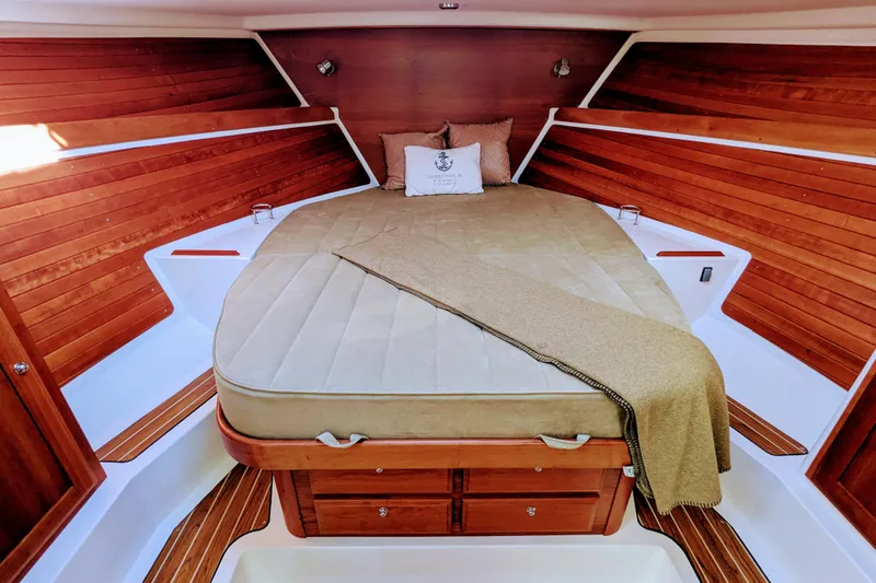 Slide: The Image of Luxurious cabin interior of 2014 Back Cove 34 boat with wooden accents and cozy bedding. - 21
