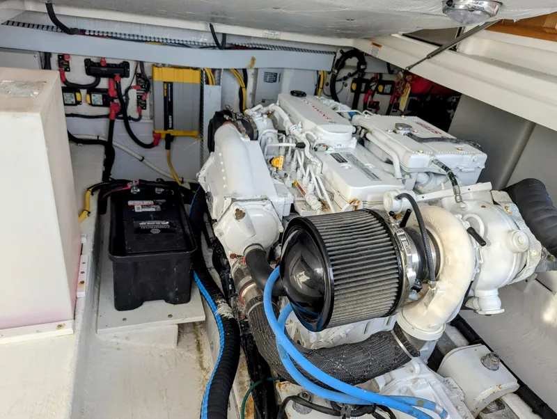 Slide: The Image of Engine room of a 2014 Back Cove 34 boat, featuring a clean, organized layout. - 25