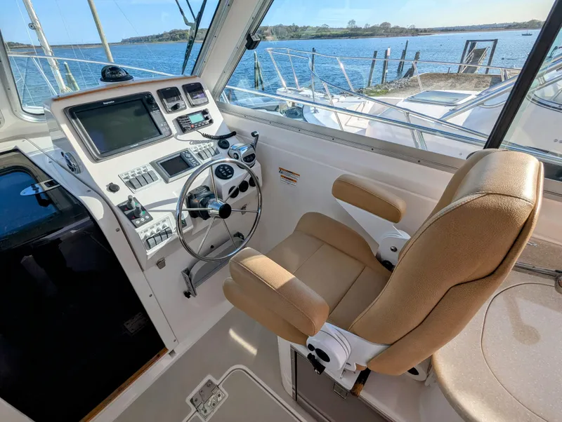 Slide: The Image of Helm of 2014 Back Cove 34 boat with steering wheel and navigation controls. - 6