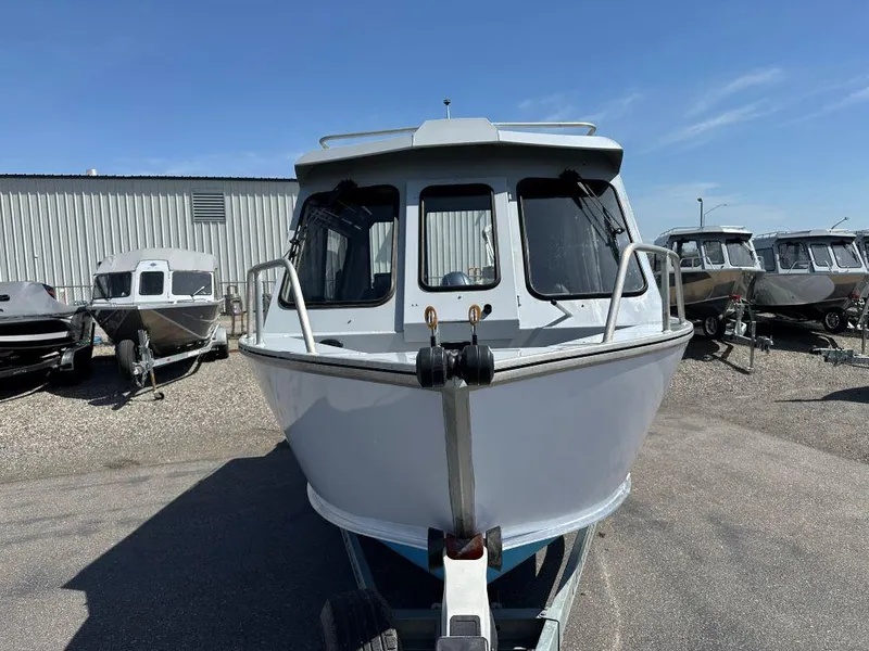 Slide: The Image of 2016 Hewescraft 220 Ocean Pro HT BH boat on trailer, parked outdoors. - 2