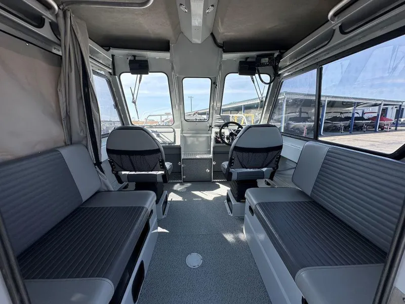 Slide: The Image of 2016 Hewescraft 220 Ocean Pro HT BH interior with seating and steering wheel. - 5