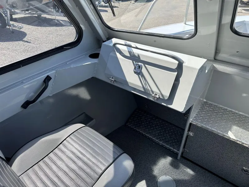 Slide: The Image of Interior of 2016 Hewescraft 220 Ocean Pro HT BH boat, featuring seating and storage. - 7