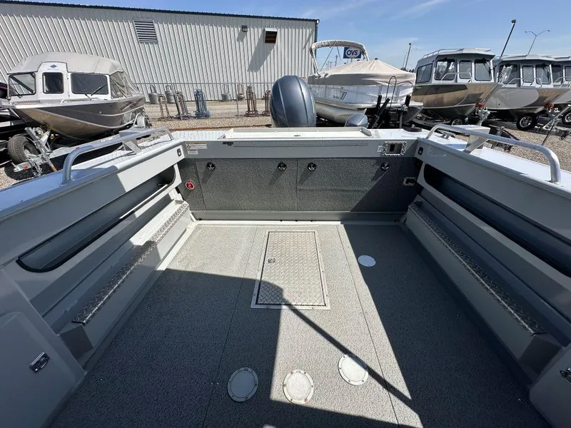 Slide: The Image of 2016 Hewescraft 220 Ocean Pro HT BH boat interior, spacious deck, surrounded by other boats. - 8