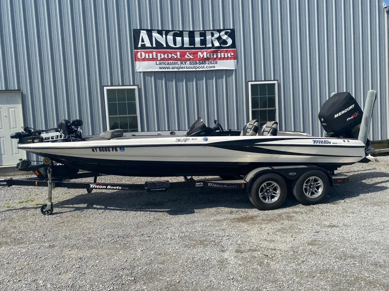 Slide: The Image of 2011 Triton 21 HP SC boat at Angler's Outpost & Marine dealership. - 1