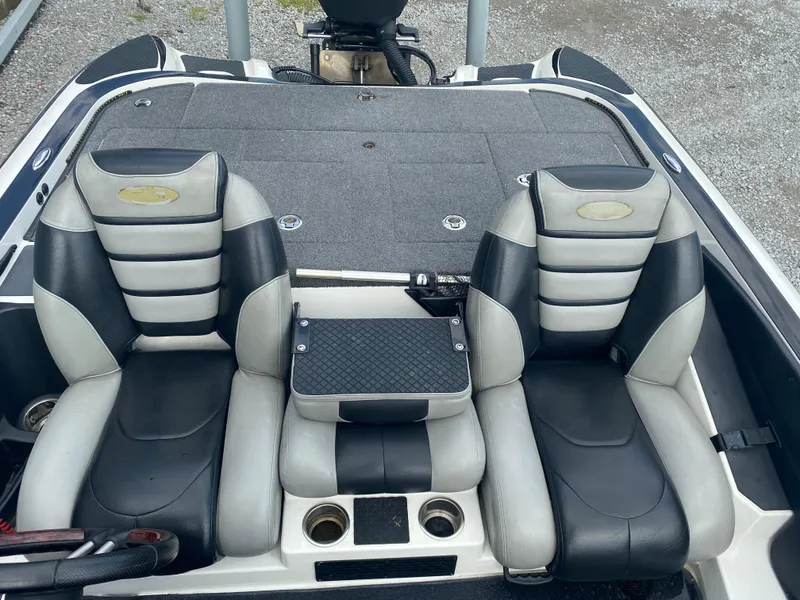 Slide: The Image of 2011 Triton 21 HP SC boat interior with dual black and gray seats. - 16