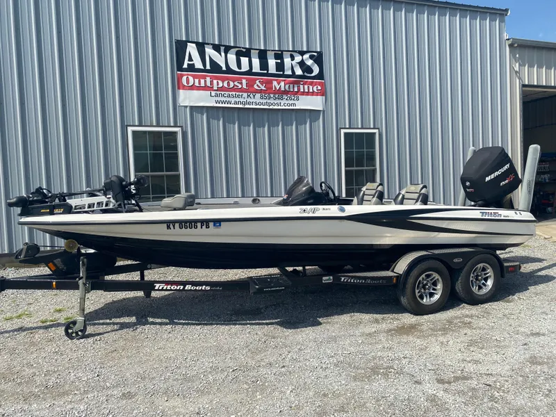 Slide: The Image of 2011 Triton 21 HP SC boat on trailer outside Angler's Outpost & Marine. - 2
