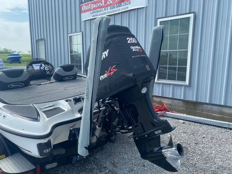 Slide: The Image of 2011 Triton 21 HP SC boat with Mercury 250 Pro XS engine, parked outside a building. - 9