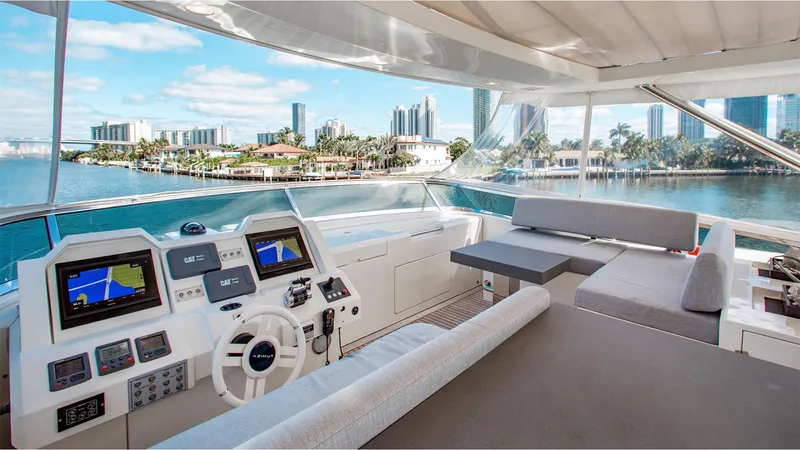 Slide: The Image of Luxurious 2010 Azimut 95 yacht interior with modern helm and seating, overlooking a scenic waterfront. - 10