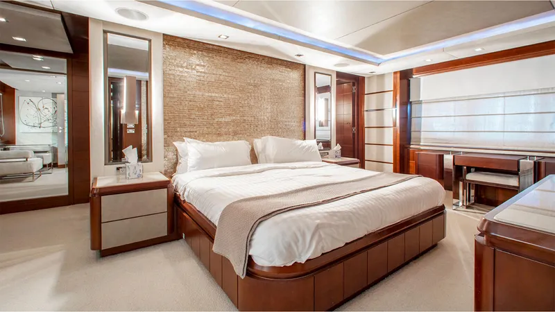 Slide: The Image of Luxurious bedroom interior on 2010 Azimut 95 yacht, featuring elegant wood finishes and modern design. - 18