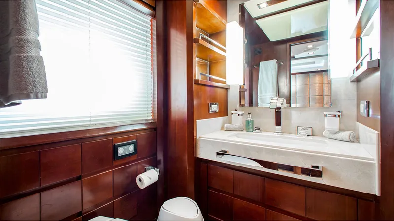 Slide: The Image of Luxurious bathroom interior on 2010 Azimut 95 yacht, featuring elegant wood finishes and modern amenities. - 23