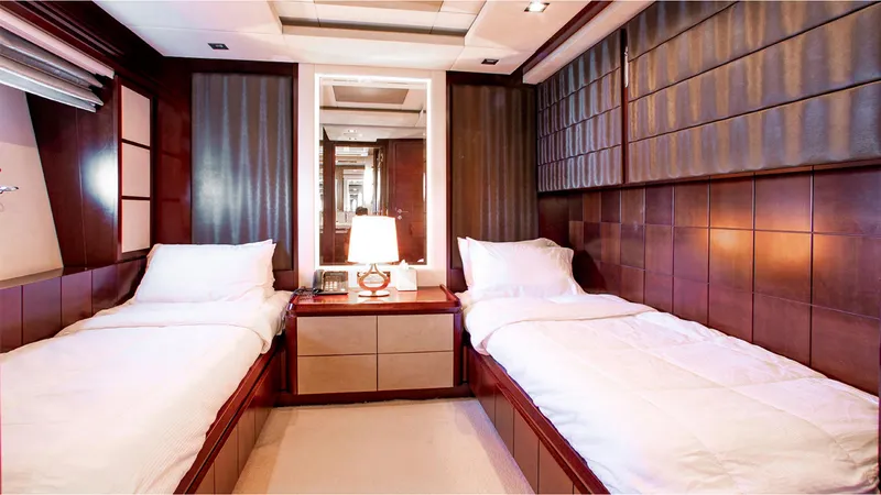Slide: The Image of Luxurious twin bedroom on 2010 Azimut 95 yacht with elegant wood paneling. - 24