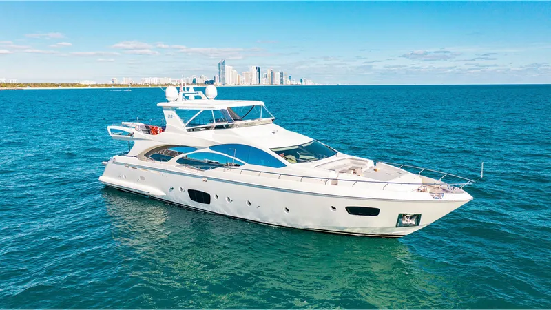 Slide: The Image of Luxurious 2010 Azimut 95 yacht cruising on open water with city skyline backdrop. - 7