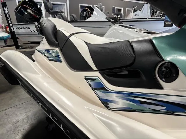 Slide: The Image of 2000 Sea-Doo GTI jet ski with sleek design and blue accents in showroom. - 4