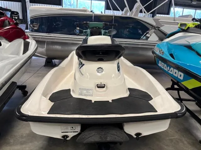 Slide: The Image of 2000 Sea-Doo GTI jet ski in storage, surrounded by other watercraft. - 7