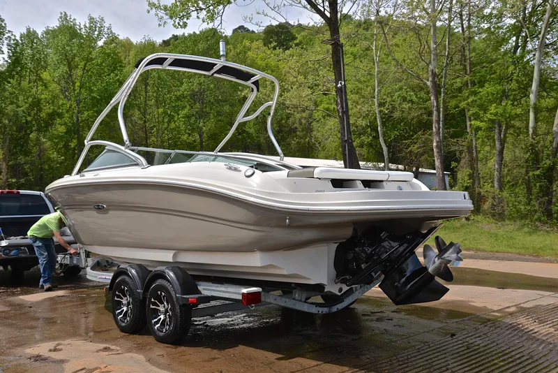 Slide: The Image of 2005 Sea Ray 220 Select boat on trailer, parked outdoors near trees. - 11