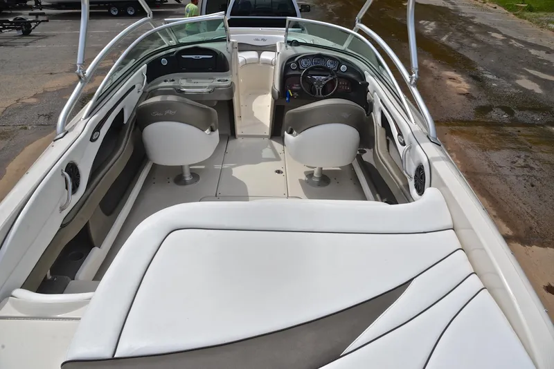 Slide: The Image of 2005 Sea Ray 220 Select boat interior with white seating and dashboard view. - 17