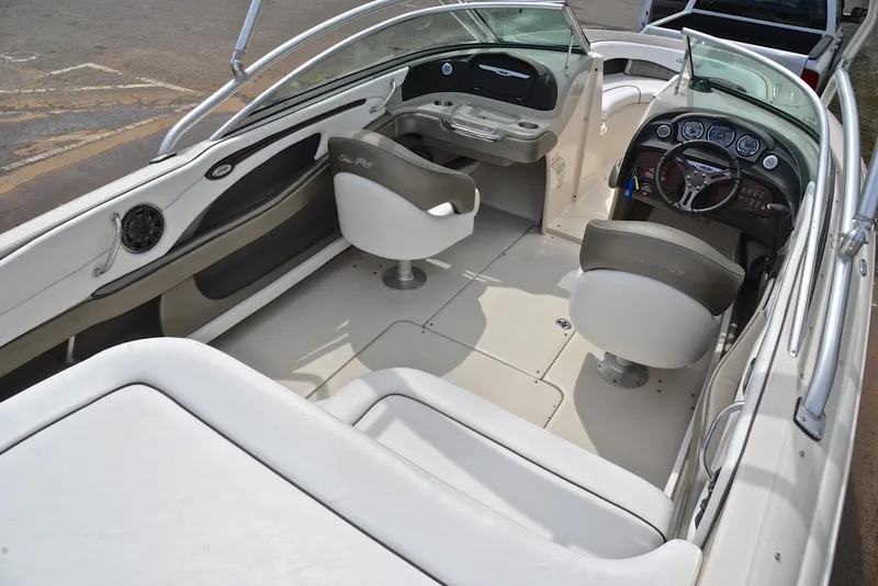 Slide: The Image of 2005 Sea Ray 220 Select boat interior with steering wheel and seating. - 18