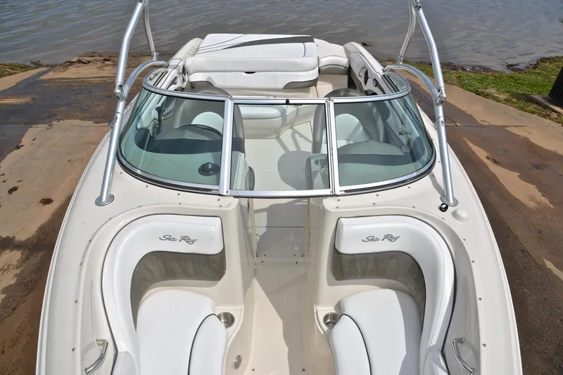 Slide: The Image of 2005 Sea Ray 220 Select boat with white interior, docked by the water. - 19