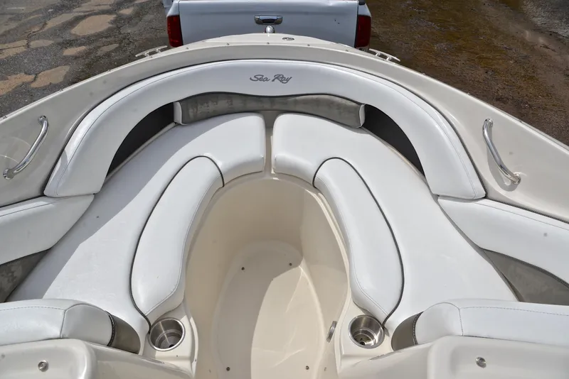 Slide: The Image of 2005 Sea Ray 220 Select boat interior with white seating and cup holders. - 20