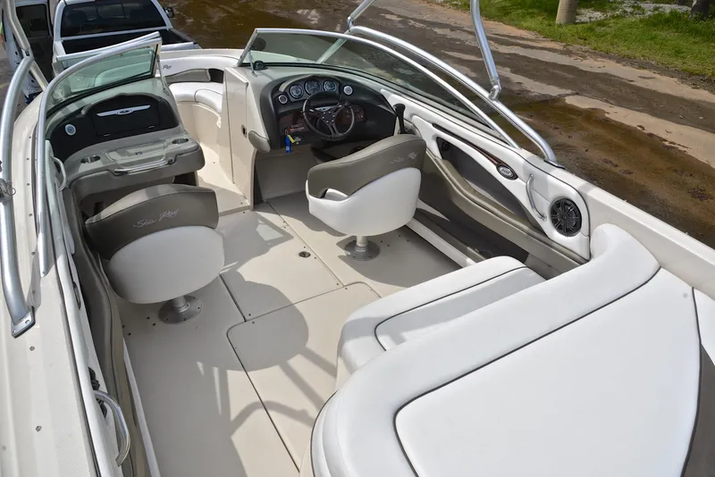 Slide: The Image of 2005 Sea Ray 220 Select boat interior with white seating and dashboard controls. - 22